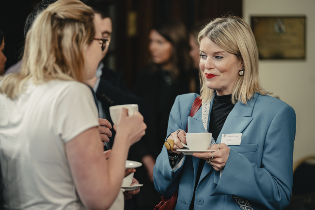 People chatting at a conference